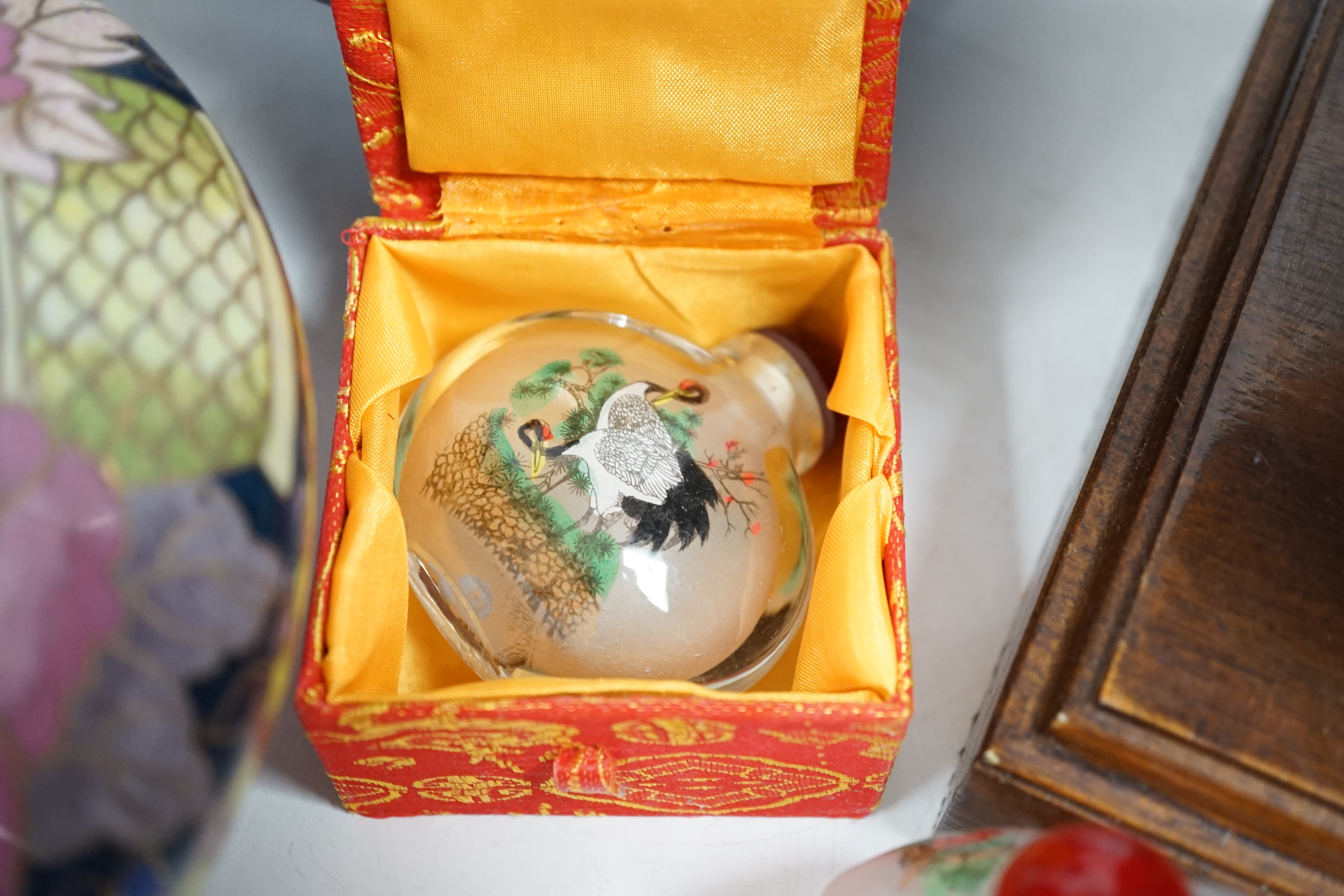 A Thai bronze model of a Buddha head, a pair of Chinese cloisonné vases, reverse painted snuff bottles etc